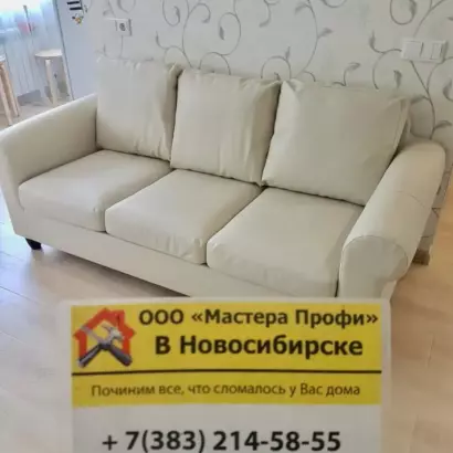 Профессиональная сборка светлого трехместного дивана из экокожи в гостиной